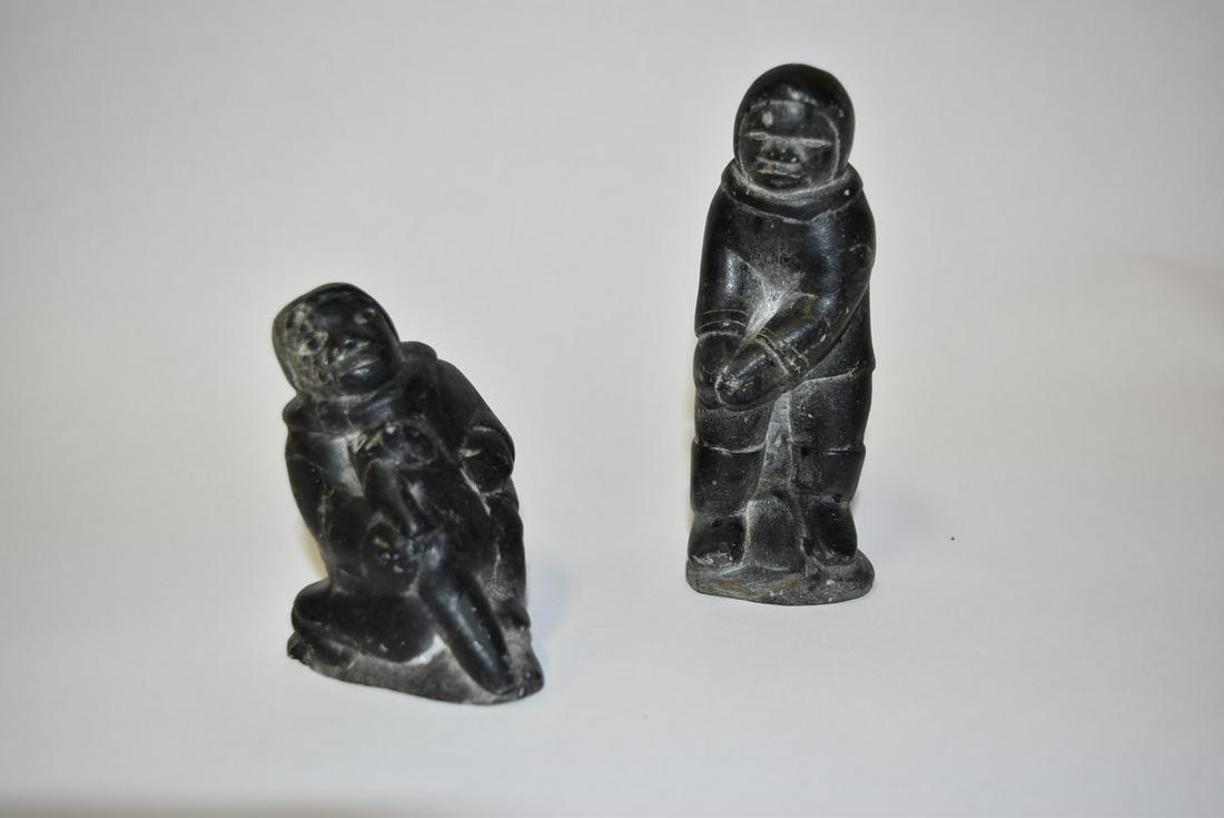 Peter Tuki; Two(2) Inuit Stone Carvings - Hunters: Port Harrison Canadian Eskimo stone carving of a Hunter with seal. Standing Hunter. Original export tag attached; 3.5in.H. x 2.5in.W. - 5in.H. x 2in.W.