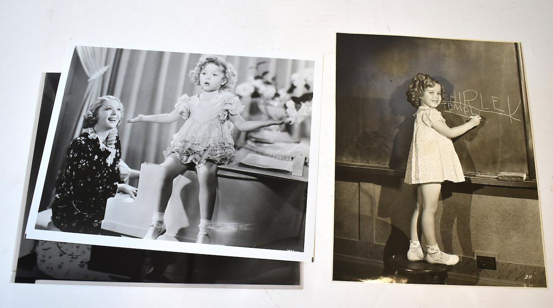 Vintage Shirley Temple Photo and Others (3): Writing her name on the blackboard with back stamp for Fox Pictures and date stamp for last time used Sept. 11, 1935 together with a second photo, atop a piano together with the negative from which it