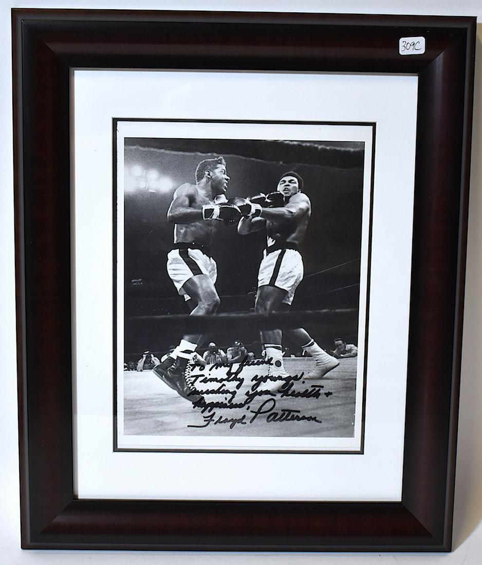 Autographed Floyd Patterson Photograph w/Ali: Boxing photo of Muhammed Ali Boxing Floyd Patterson autographed in black Sharpee by Floyd Patterson. "To my Friend, Timothy Youngs, Wishing you health and happiness, Floyd Patterson. Certificate of Au