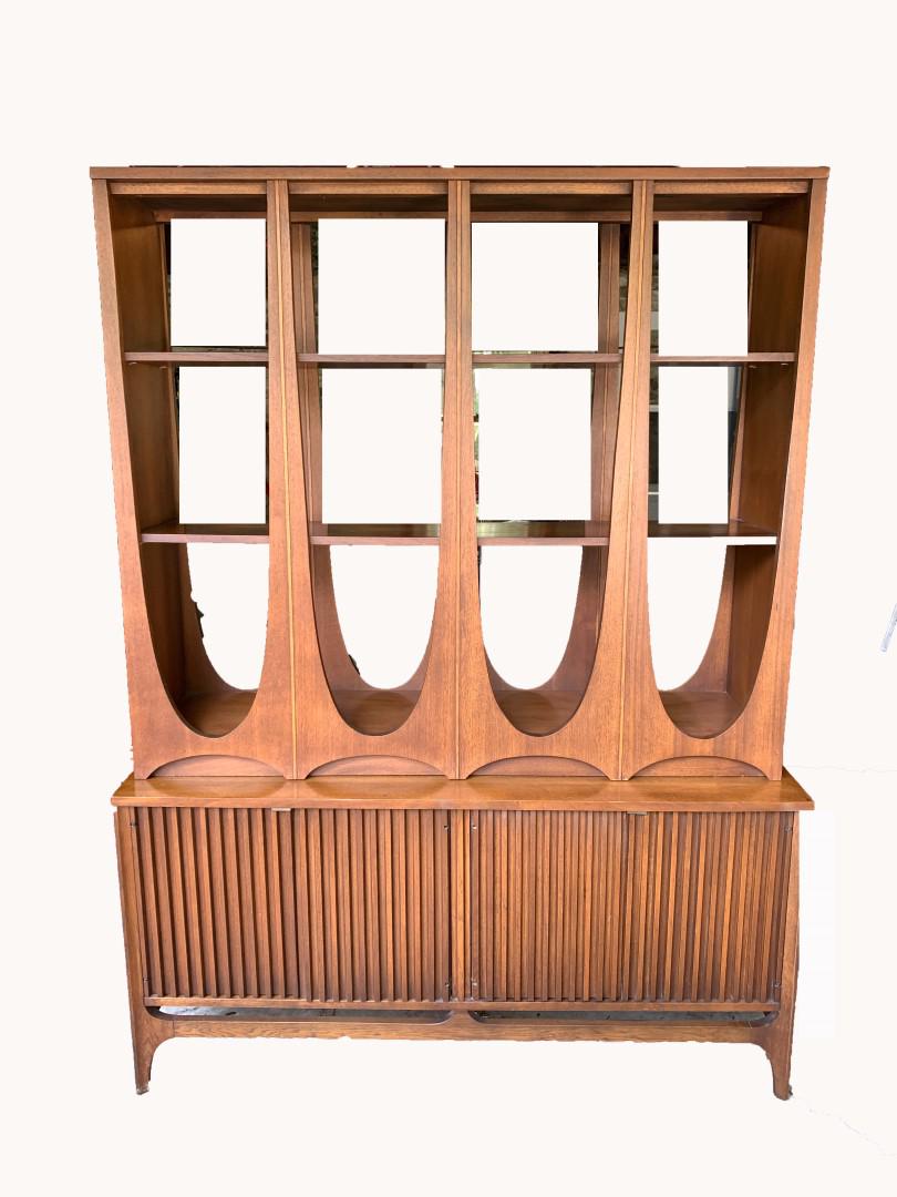 Brasilia Mid-Century Modern Walnut Wall Unit: Modernist walnut wall unit. Three(3) shelves. Four(4) door lower cabinet. Three(3) drawer interior. Brasilia series for Broyhill Premier, 1962; 72.75in.H. x 54in.W. x 17in.D. PLEASE NOTE: Due to size 
