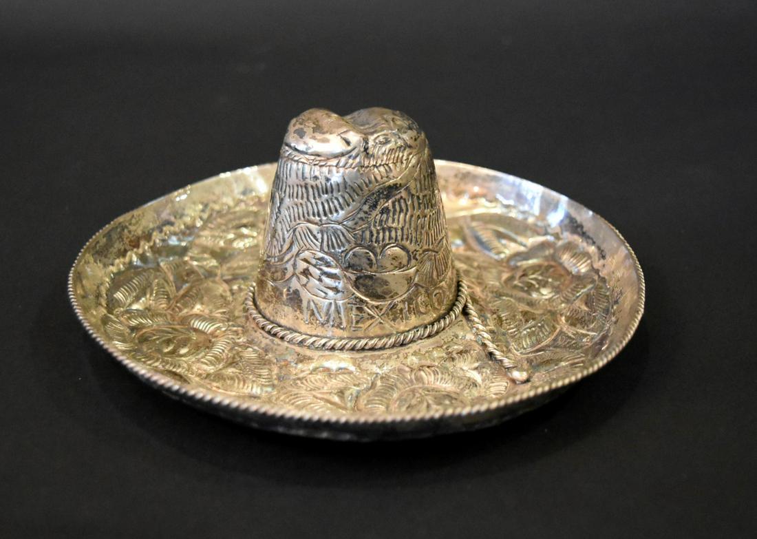 Mexican Sterling Silver Sombrero: Fancy sterling silver sombrero. Hand chaised with applied braided deocration. Inscribed Mexico. Marked SG Sterling 925 Hecho en Mexico; 3in.H. x 7in.W.