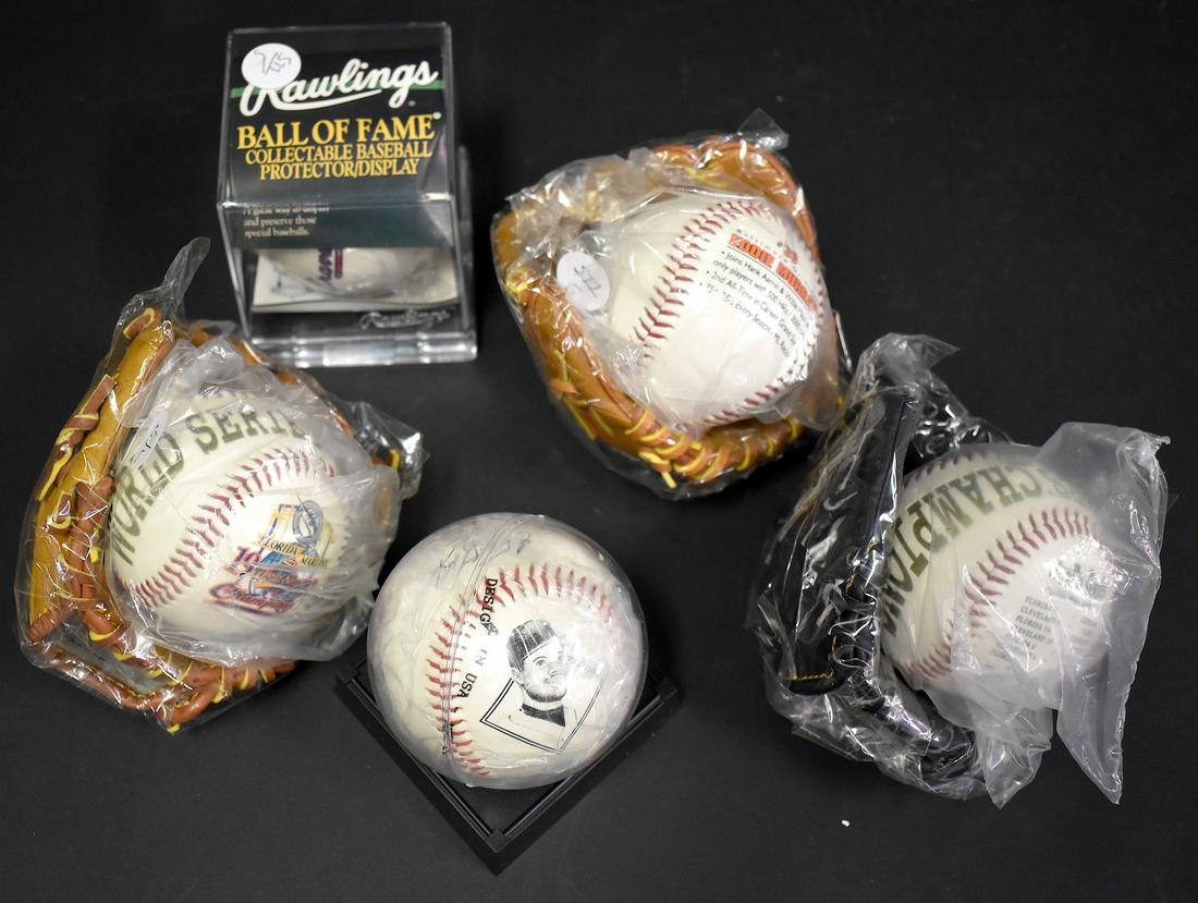Collectors Lot of Baseball Memorabilia: Included in the lot is a Rawlings 1999 Official World Series Ball Braves and Yankees, which Yankees won in four with stats on it and team logo; a Ken Griffey Jr. ball with a replica signature; a Flori