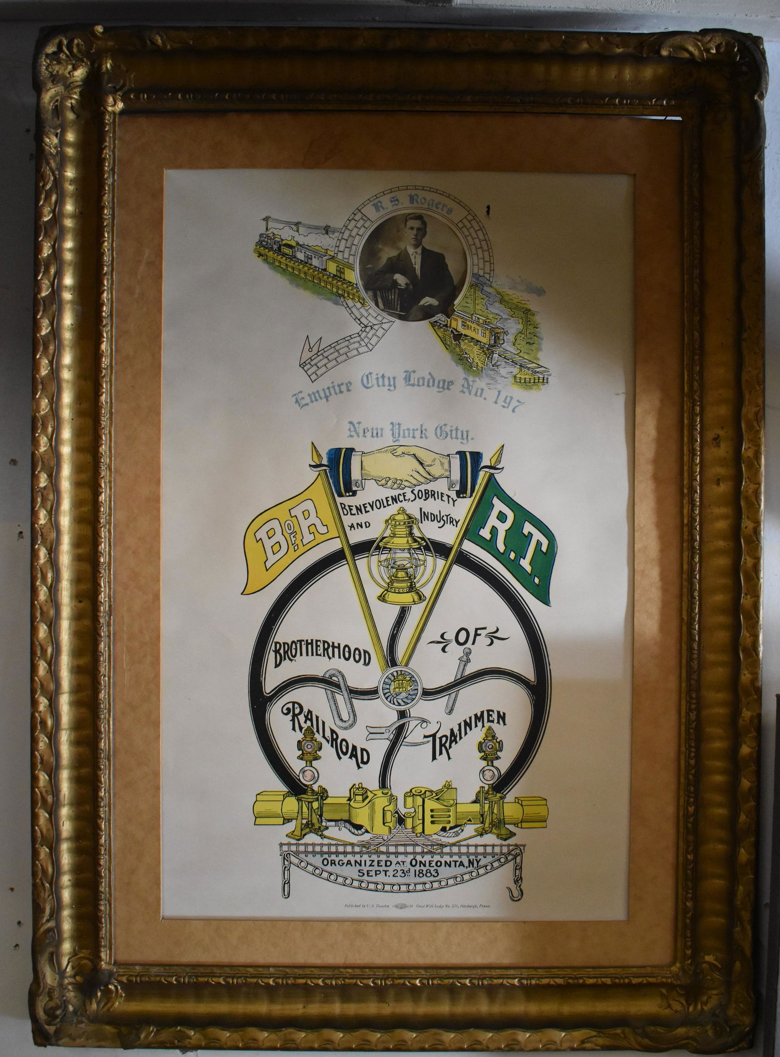 Brotherhood of Railroad Trainmen Memorabilia: Lot Includes a framed Memebership Poster for the Empire City Lodge No 197. NYC. Overall Size 29"H x 20"W. A Brooks Uniform Hat for a trains conductor. 5 McQueen Jupiter 29 Cent Stamps. 9 B of R.T. mem