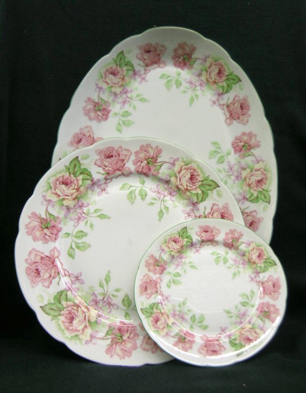 Bernardaud Limoges China: Twelve pieces. Eugenie de Montijo pattern. Copied from those made by Bernardaud, for the 1867 Paris Exposition. Platter, six dinner plates, five desserts. 15-1/2"L.; 10" d; and 6-1/2" d. One dinner pl