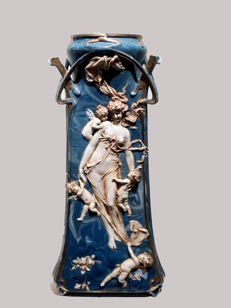 Amphora Style Porcelain Figural Vase: Figural porcelain vase. Bas relief decorated panel with nymph and cherubim. Marked at the underside; 18in.H. x 9in.W.