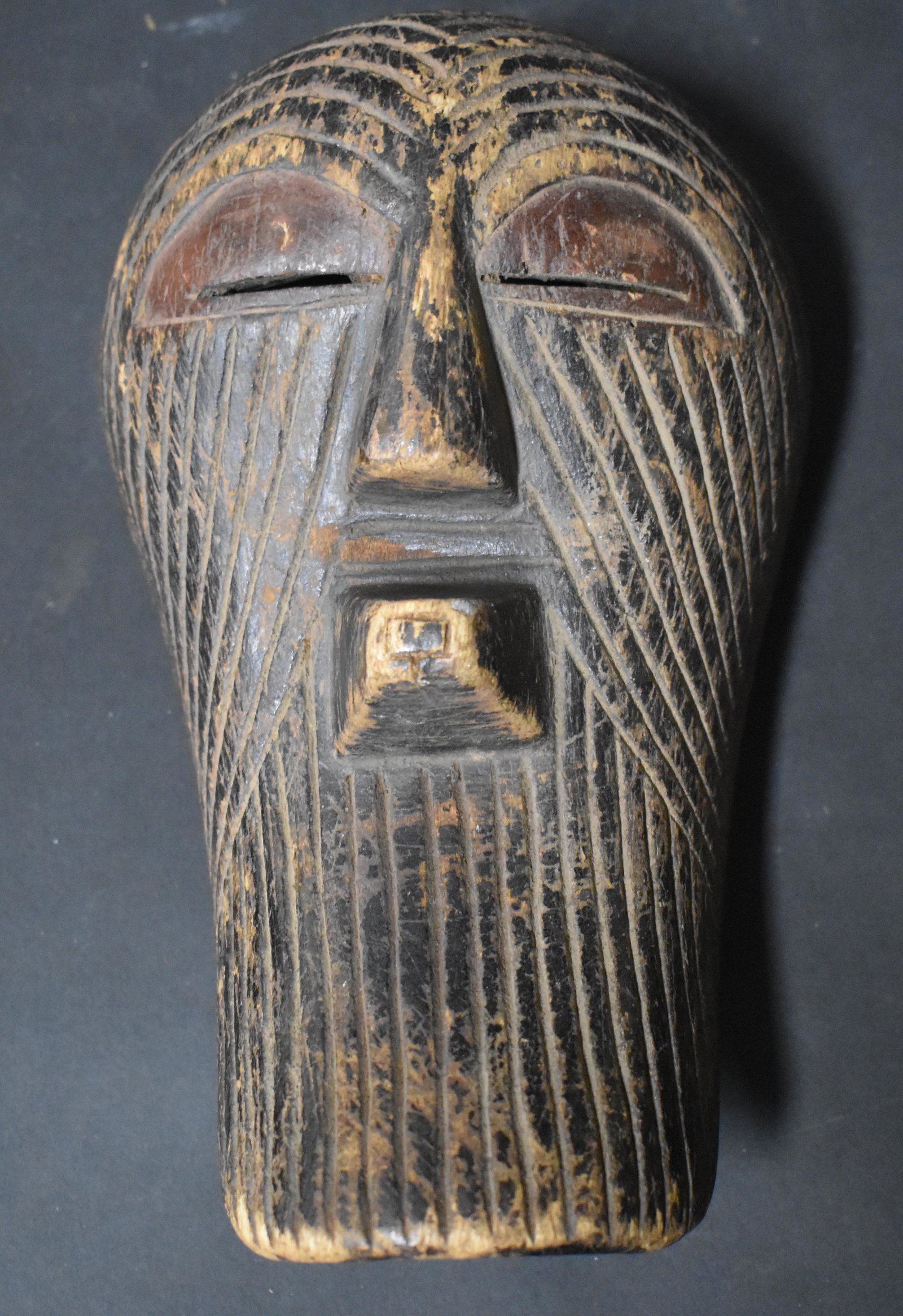 Antique Songye Mask. Copper Eyes: Size 9" long .****This, an item from a local elder, older than his 60 years, up until this past month, a very active, eclectic and constant collector. Responding to recent health news, he has chosen o