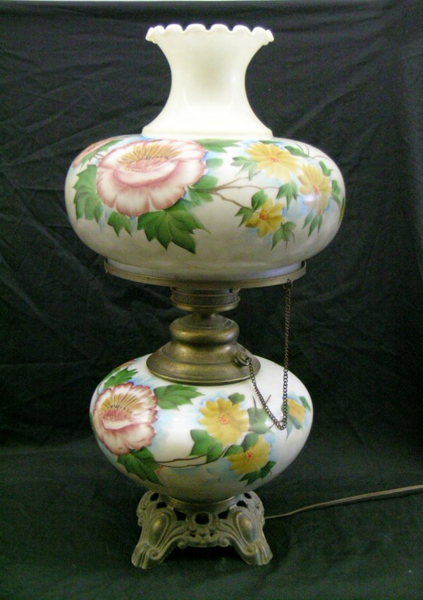 GONE WITH THE WIND LAMP: White base and shade with hand painted rose and yellow flowers. Brass fittings. Electrified. Size: 27-1/2" h x 15" w