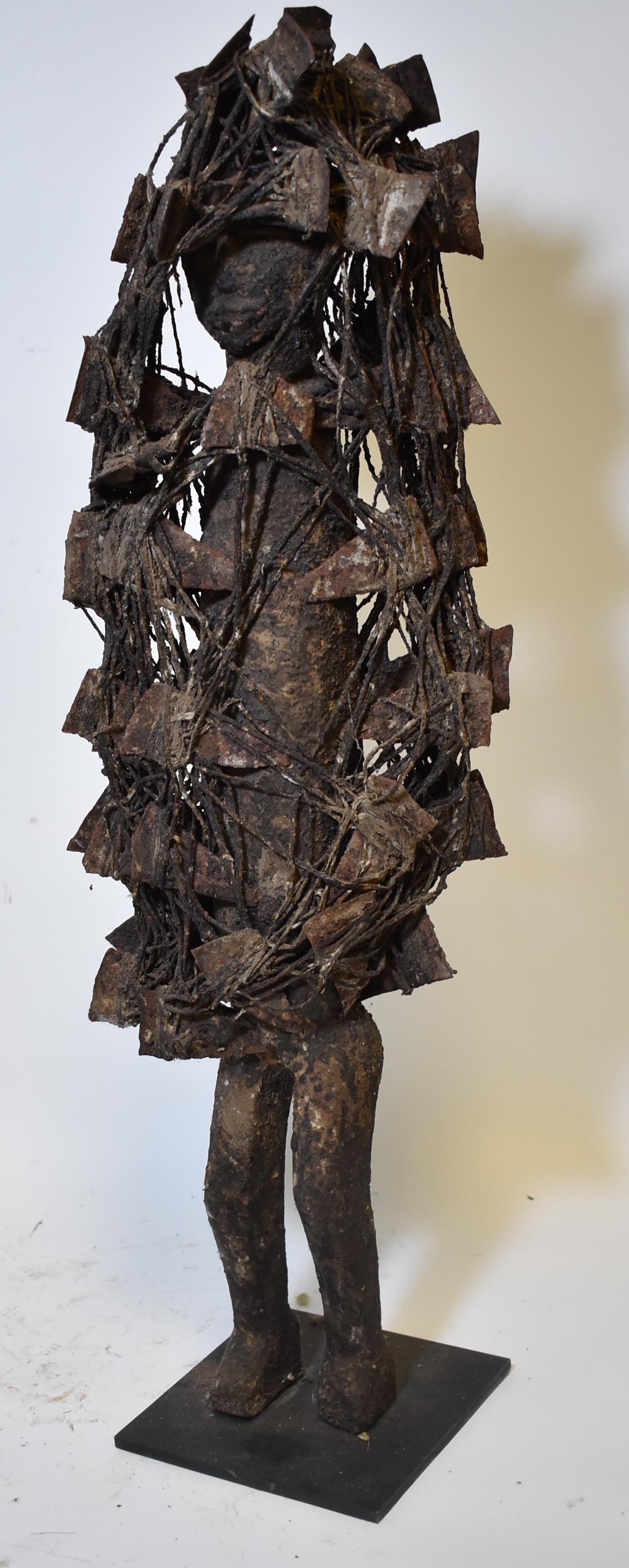 Possibly Senufo Ivory Coast Divination Figure: Male figure covered with metal blades and cording. Also with dried magical potions. Highly unusual . Untouched old surface. Perhaps more than 100 years old. With a custom metal stand. 27 1/2"H