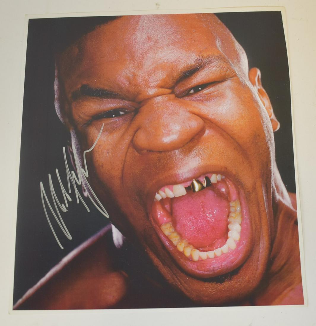 Mike Tyson Autographed Photograph: Autographed color photograph. Screaming Tyson. Silver felt tip pen signature; 12in. X 10.5in.