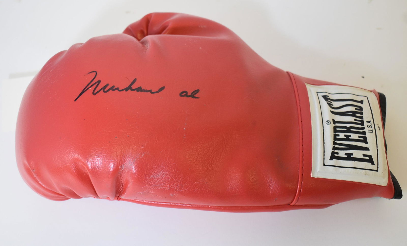 Muhammad Ali Autographed Boxing Glove: Autographed boxing glove. Red Everlast. 16oz. Black felt tip pen signature; 12in.