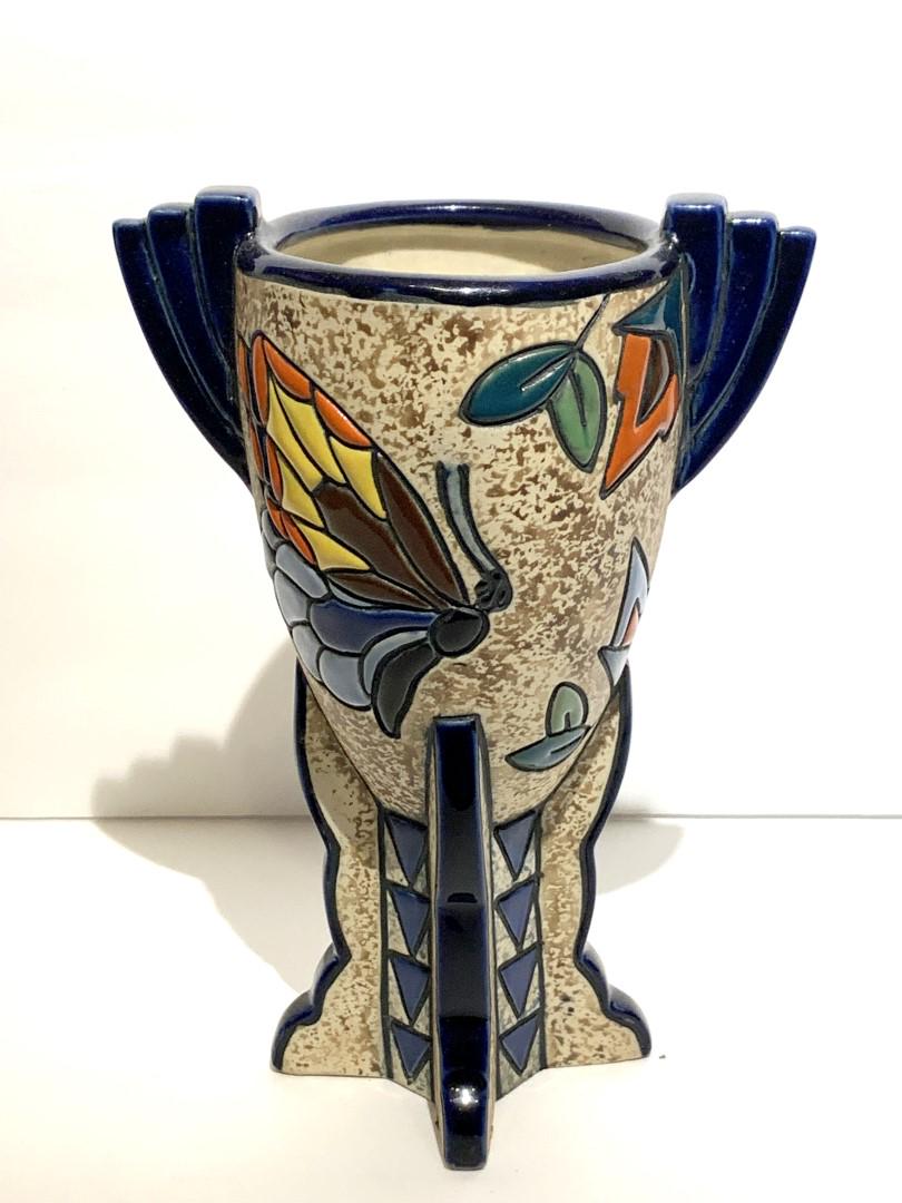 Amphora Art Deco Enameled Pottery Vase: Enameled pottery vase. Art Deco form decorated with butterflies and stylized foliage. Marked and numbered at the underside; 8.25in.H. x 6in.W.