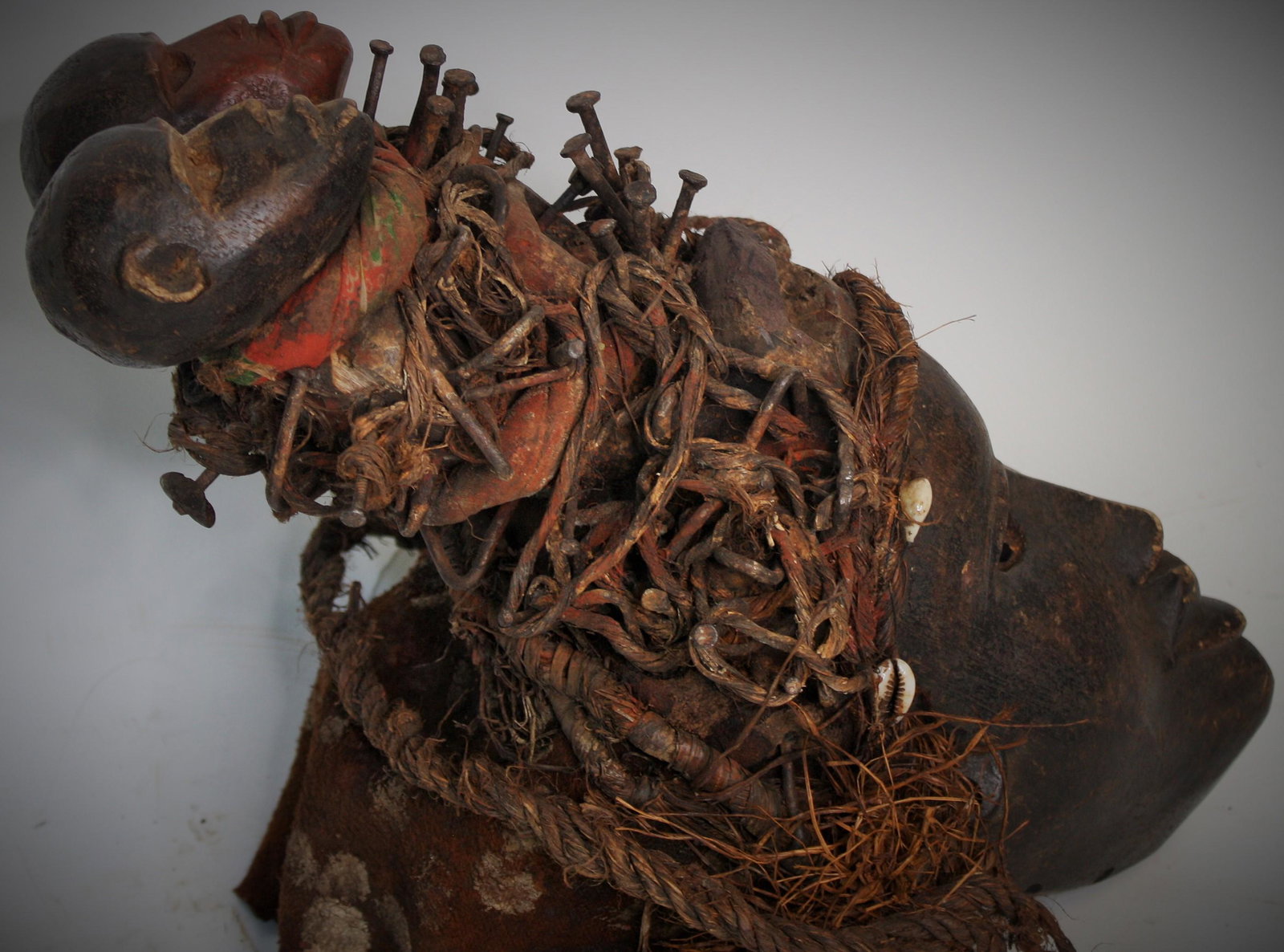 Strong Central Congolese Fetish Mask: 19th C.-1900 Old two color earthtones. Untouched natural surface. With original wovenwork and basketwork support. Custom ironwork stand Mask is 18"H Overall size. 27 3/4"H