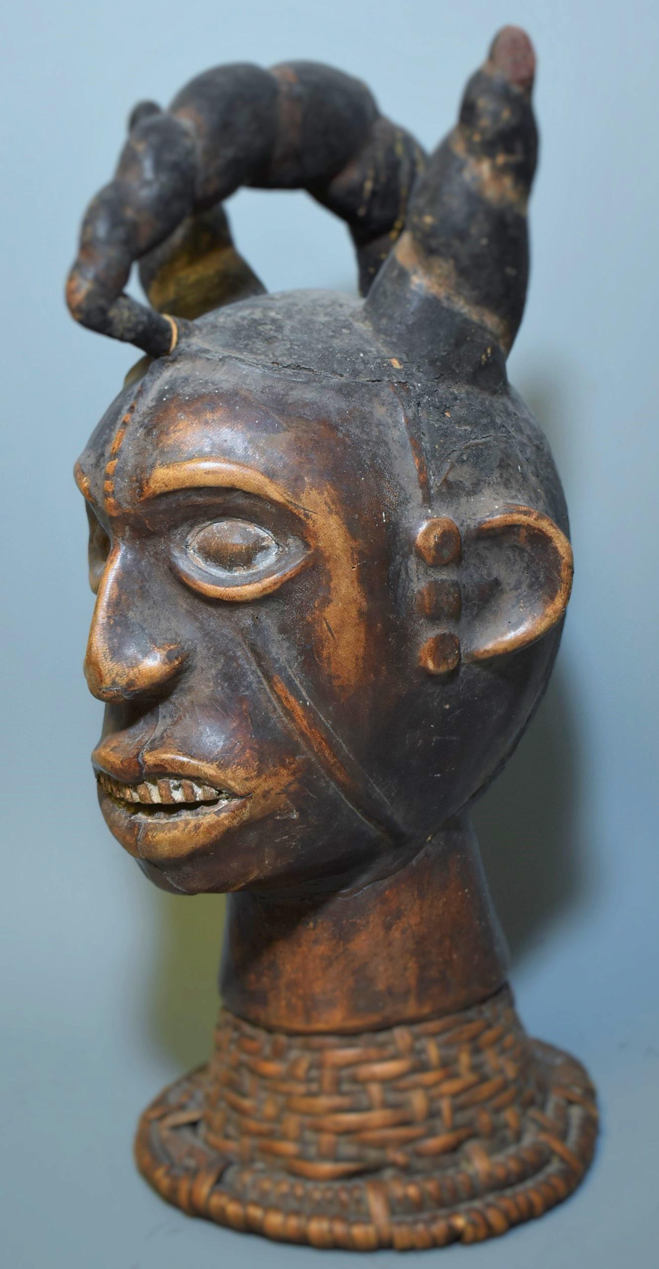 Powerful Head Mask. Ekoi Tribe: Cross River Region separating Nigeria and Cameroon. This head dress is skin covered on the face and ears only. The skin, thin. The pc possibly 18th C. and the skin human. Fully original surface. Museu
