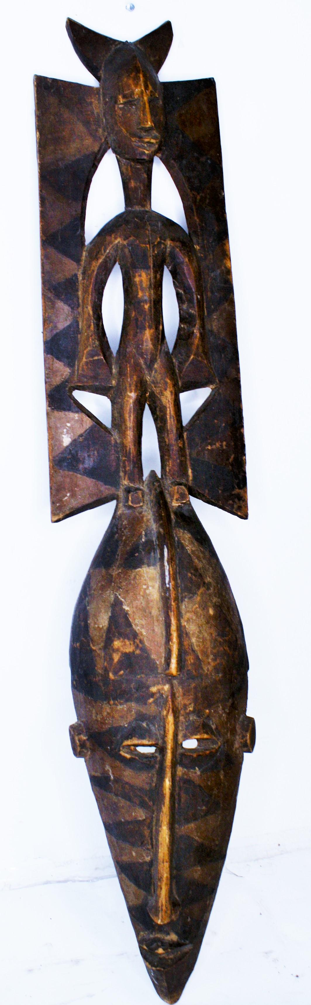 Fine Early Mask, South Saharan: Probably Bobo, Museum calls it Bamana.(Mali) Original Earthtones. C. 1900. Tribal. Minor splits in the figural body. 45 1/2" H.