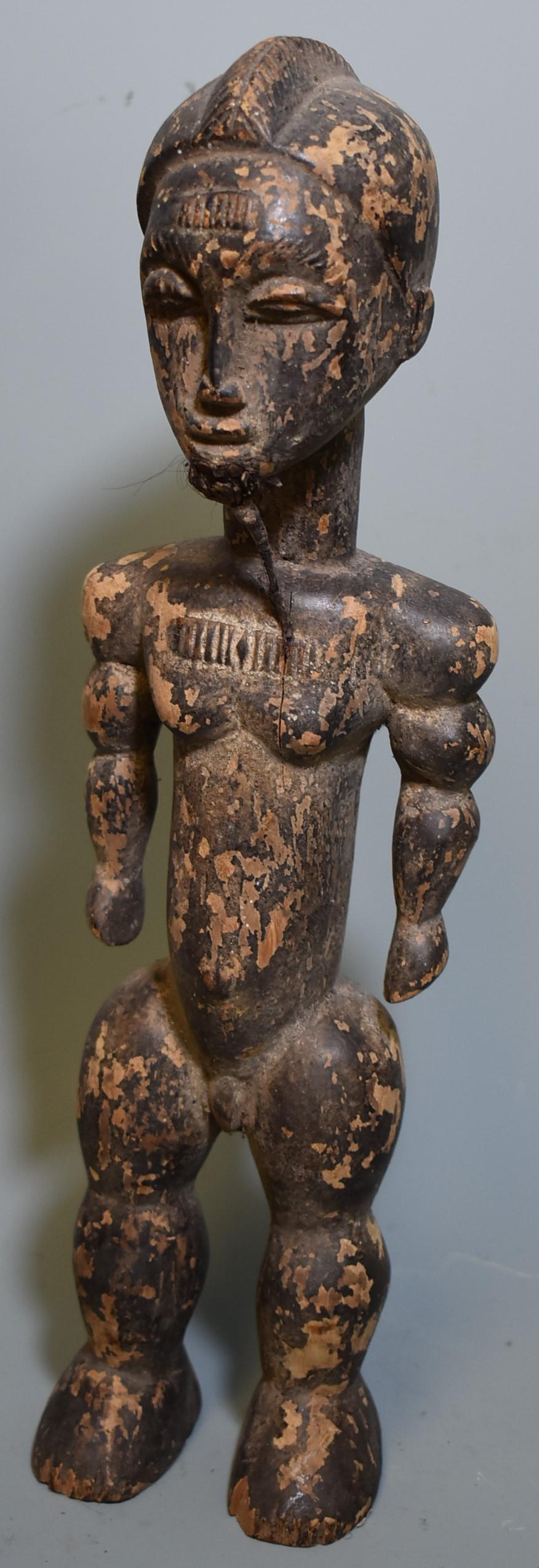 Ivory Coast Male Figure, Early 20th C.: Likely Senufo. With attached beard and a strong old flaking surface. 16"H.