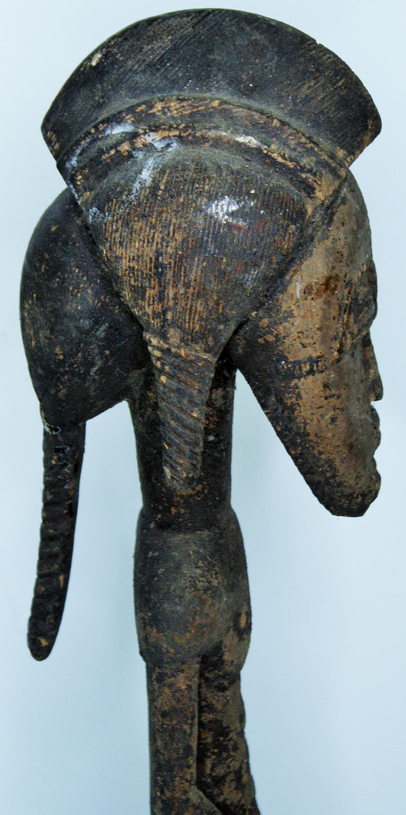 Strong Old Yaure or Guru Male Figure: Heavy dense wood. Four masks surround the base. A fine carving 24 1/2"H