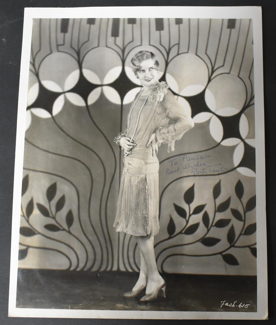 Vintage Photo Ruth Taylor Sgd.: Signed. "To Paula. Best Wishes, Ruth Taylor." With a publicity snipe on the back, as well as a back stamp for Movie Star News. 7.75"x10".