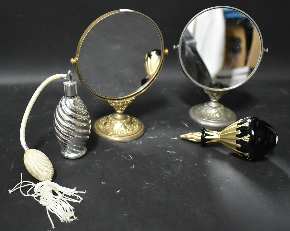 Dressing Table Lot Perfumes & Mirrors: Adjustable vanity mirrors, both antique, matching but with silver plated base and gilded bases. 2 perfumes in the lot (1 does not stand on its own). Five items in lot. Mirrors are 8.5 tall and perfume