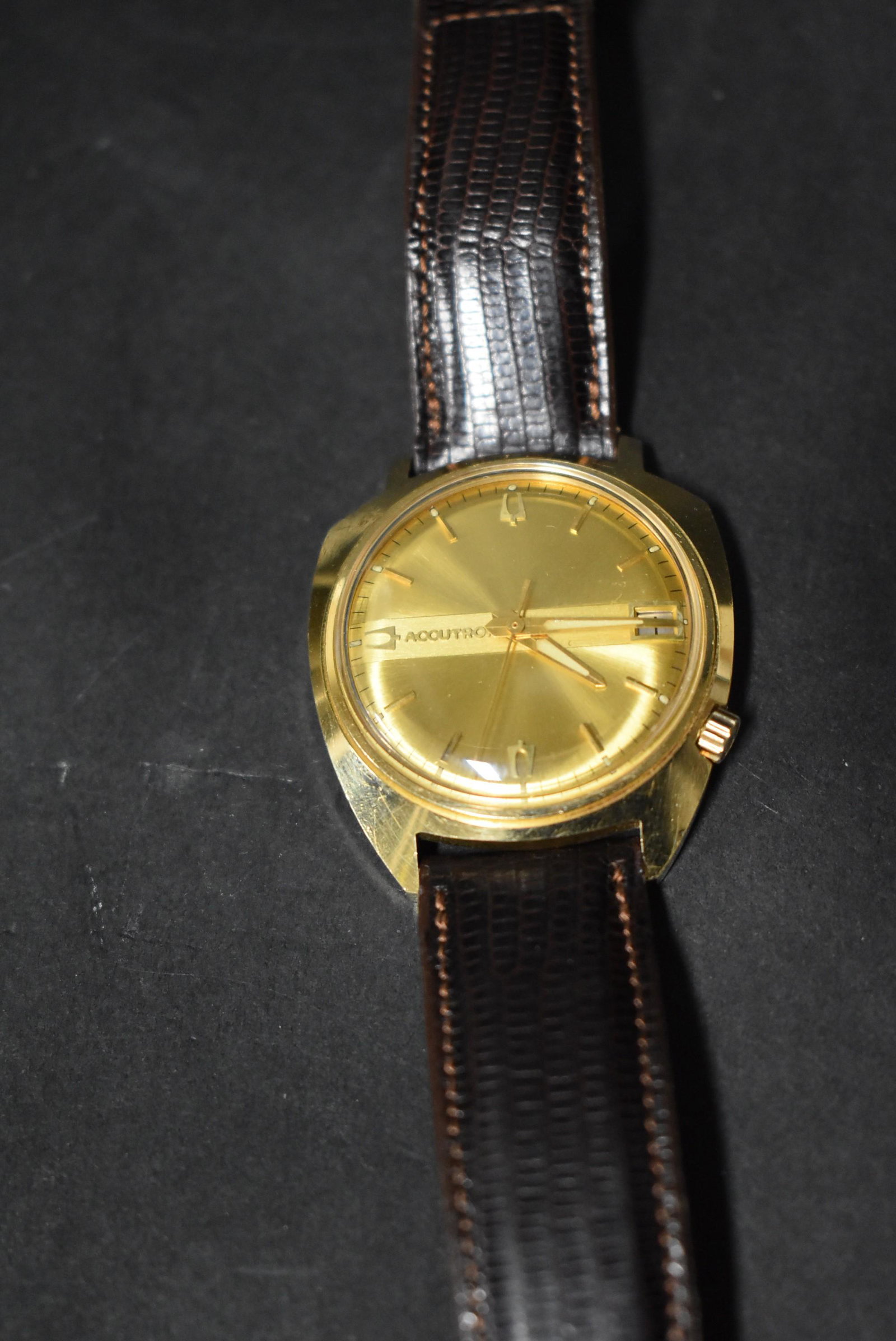 Bulova 14KT Gold Man’s Vintage Wristwatch: Accutron. Lizard Skin Leather Band. Marked 14KT. Engraved, "6-69 MOM & DAD" on back of face.