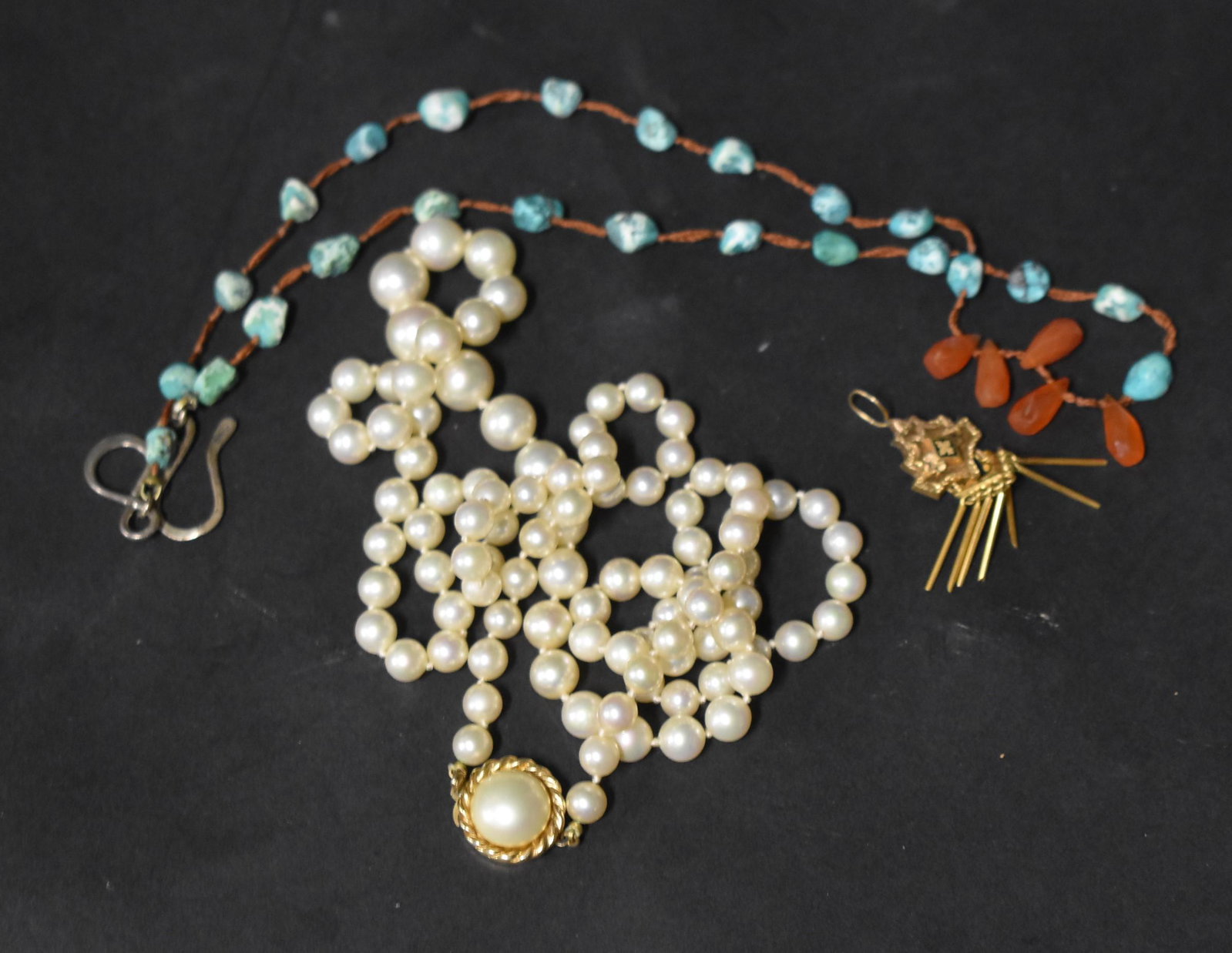 Vintage Costume Jewlery: Fine graduated pearl necklace; fine luster, gold clasp and gold pendant. Turquois and carnelian necklace.