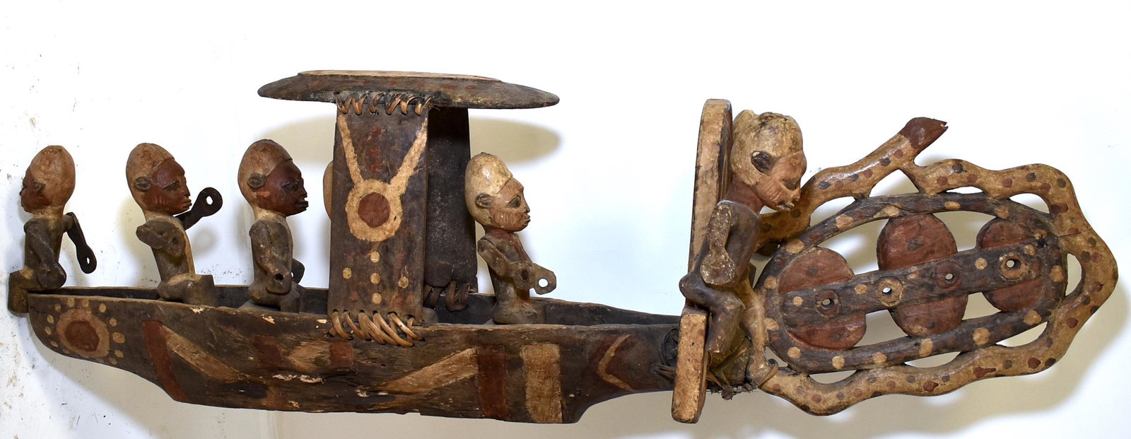 Unusually Carved Yoruba Boat w/ Figures.: Seven Male Figures. Oars are missing. Orignal Painted and Ratton Bindings. Untouched Surface. Exceptional and unique. Size 14"H x 49"W