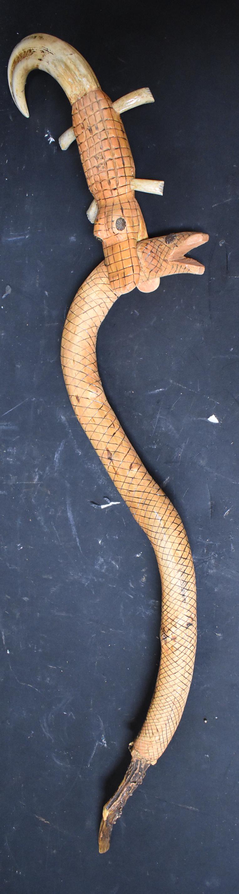 Ron Cisco Folk Art Walking Stick: An alligator with a serpent in his mouth. Boars tusk handle.Antlet bottom sgd. R Cisco 32 inches iong
