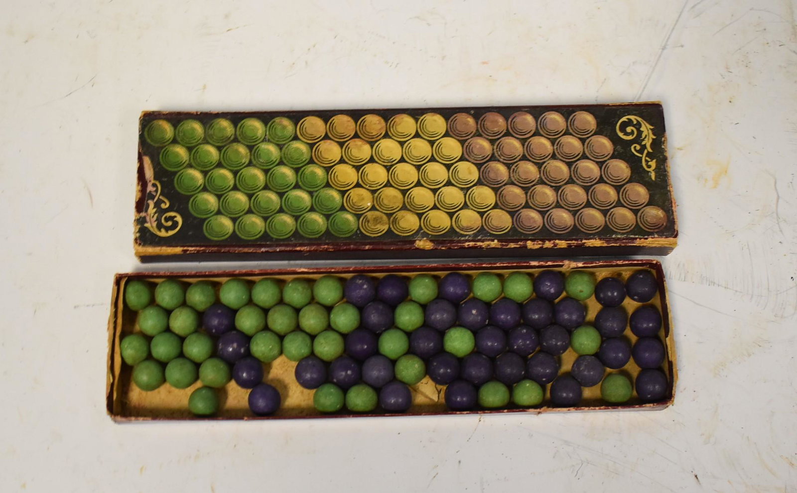 Turn of Century In box Marbles (Approx 50): Rips on Box. mixed box of purple and green marbles.