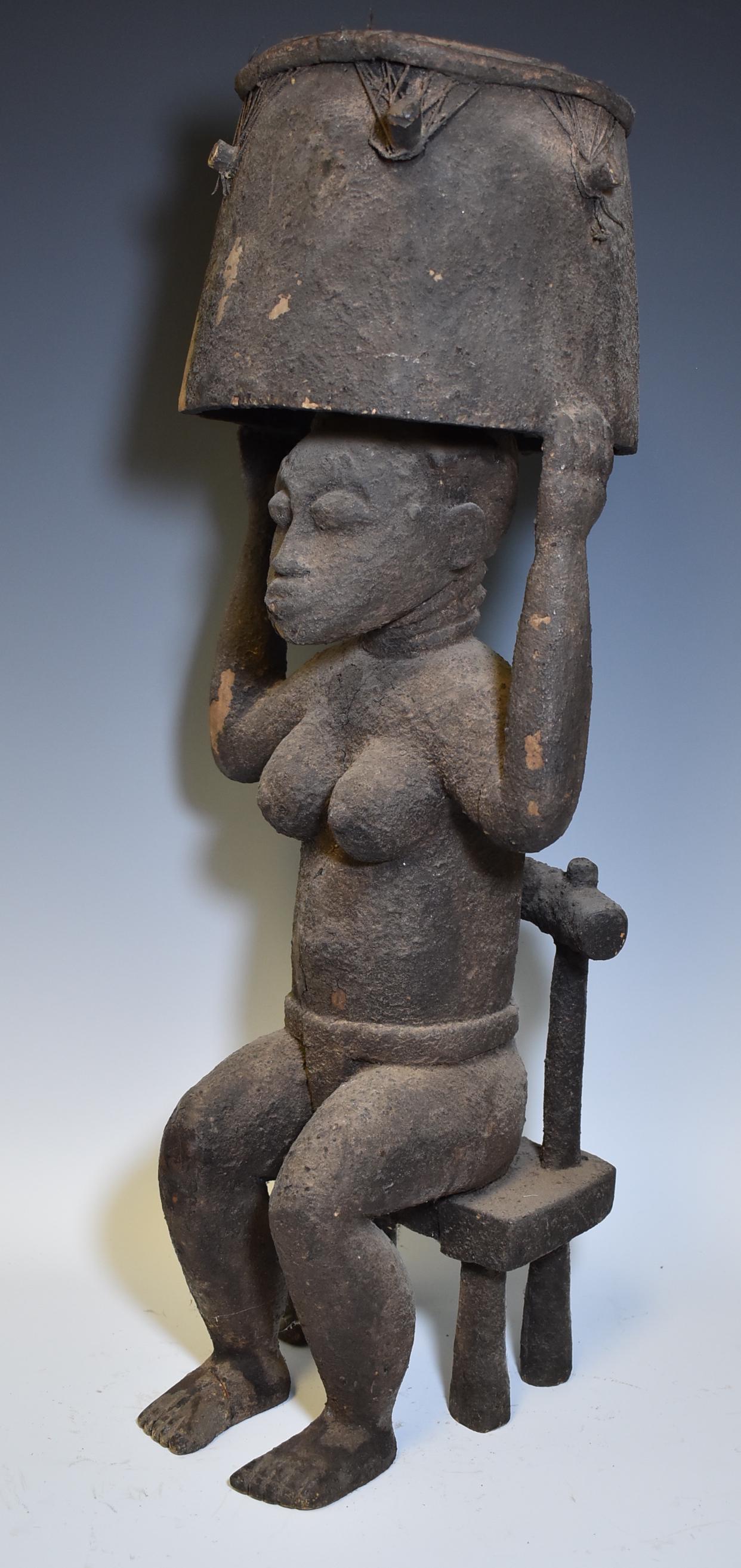 Old Senufo Seated Female: Holds aloft a drum with orginal skin. Heavily encrusted Chicken blood surface. Size 25"H X 7"W (drum)