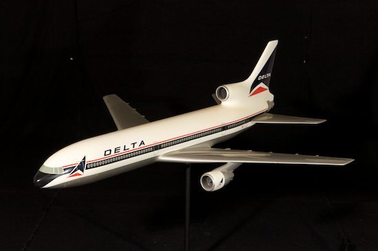DELTA AIRLINES COMPOSITION PLANE MODEL: painted composition, Douglas DC10, 43in. L x 38in. W., with metal stand