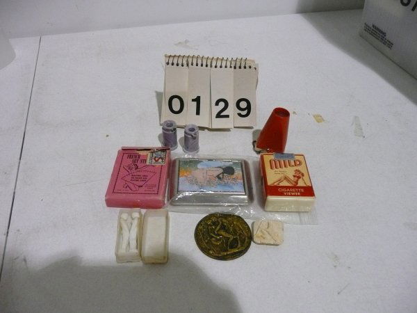 VINTAGE EROTIC ART AND COLLECTIBLES: Lot of miscellaneous erotica including 3 plastic peep shows,1 cigarette package peep show, 1 plastic case with plastic male and female figures, 1 deck of erotic playing cards, 1 brass circular medalli