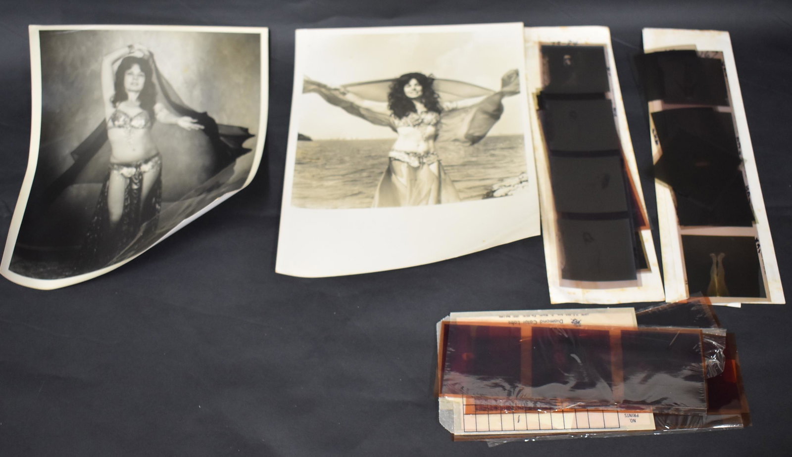 Sylvia Widener Collectible Lot (35): Includes 10 posed shot negatives; 8 in silver and blue costume, '73-84; 8 belly dance negatives; two 8 x 10 vintage photographs ; negatives of Sylvia in the park (red belly dancer outfit); (14) small 