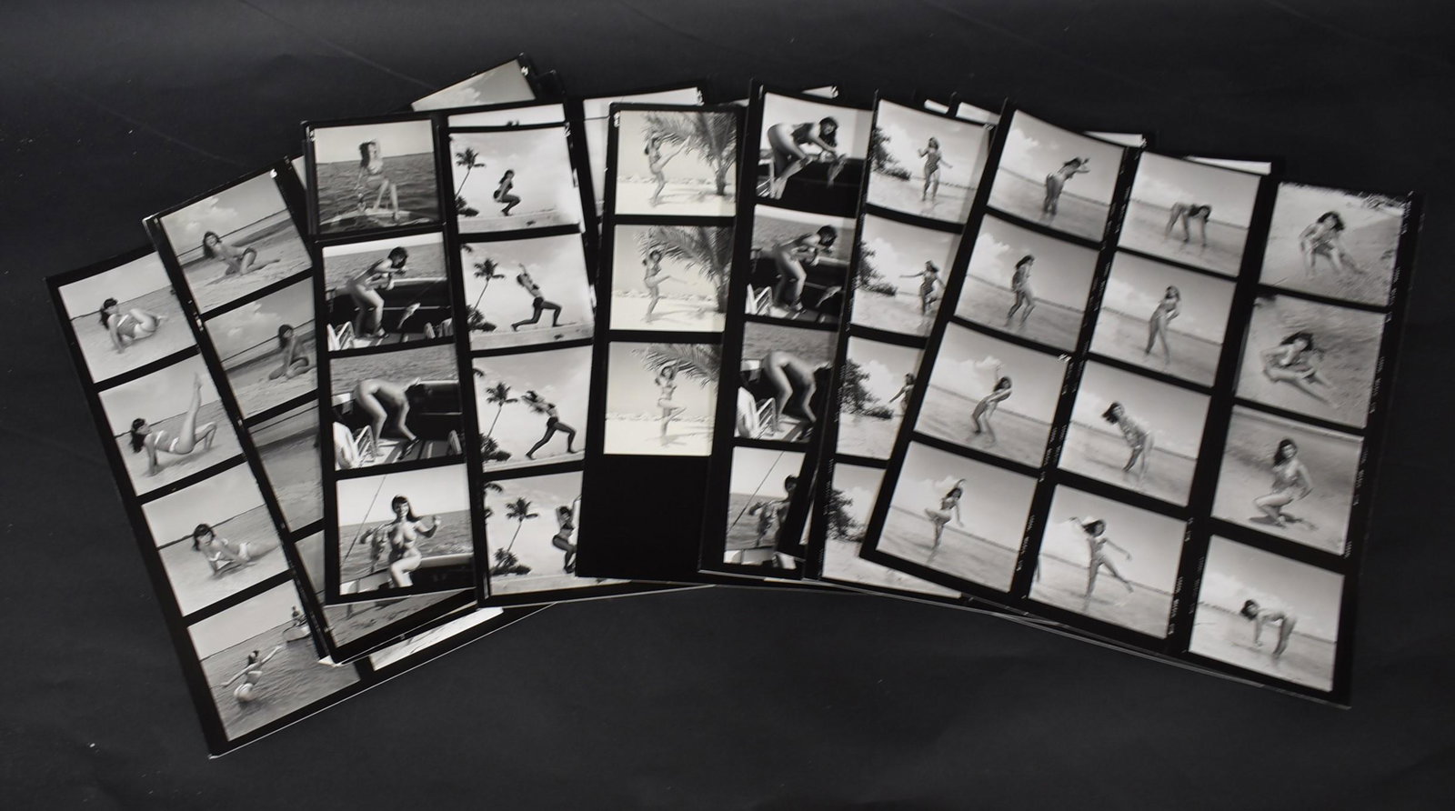 Bettie Page Contact Sheets (10): 132 images of Bettie Page at the beach and fishing on a boat. Many with backstamps for Bunny Yeager and Eric Kroll. Some with stamped notations that they had been catalogued by Kroll for Yeager's book
