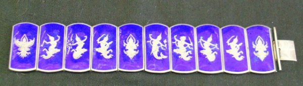 STERLING SILVER AND ENAMELED BRACELET: Heavy cobalt blue enamel on sterling bracelet depicting various Balinese Dancers in the 10 large links. Marked Sterling. Made in Siam.