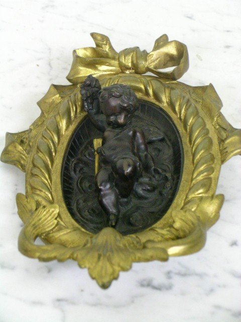 19TH CENTURY BRONZE PLAQUE: bronze and dore plaque with cherub; 8 in. H.
