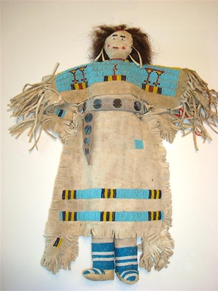 AMERICAN INDIAN LEATHER AND BEADWORK DOLL: Leather and beadwork American Indian doll with leather body and face, human hair, beaded eyes and mouth.15" H.