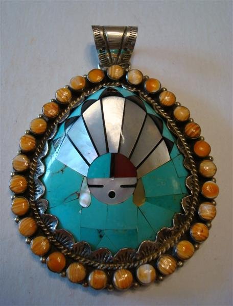LAMBERT HOMER SR. PENDANT: An American Indian Zuni sterling silver pendant with turquoise,, abalone, jet inlaid on a shell base with a coral surround. Signed L. Homer '58. In 1975, a Lambert Homer Sr. mosaic pendant sold at Sot