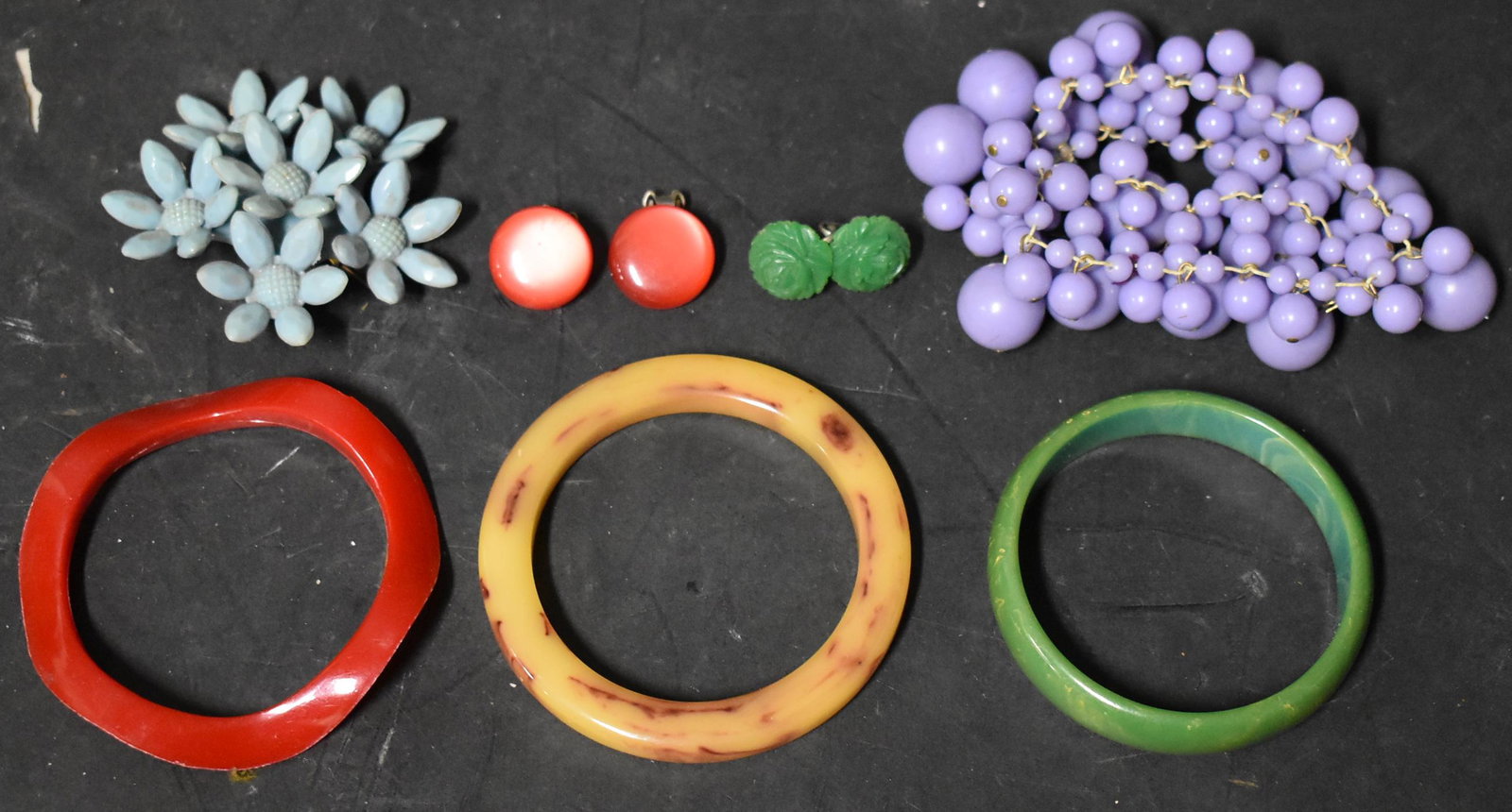 Collector's Lot of Bakelite Jewelry (7): 3 Bangles, a Purple bracelet,a brioche, and two pair of earrings.