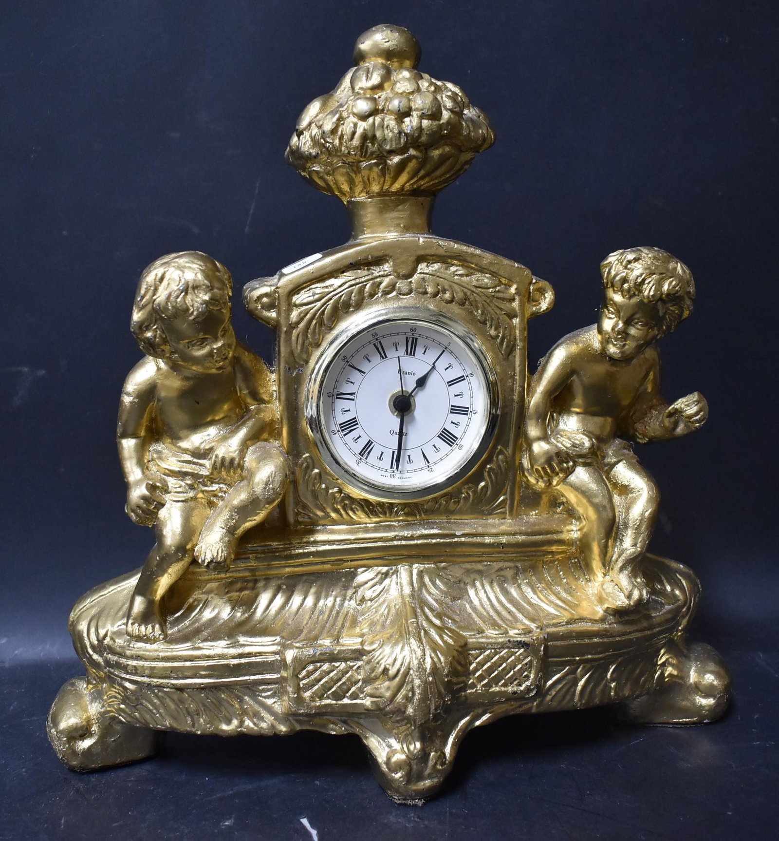 Bronze Figural Mantle Clock: Marked on the dial Uranio West Germany. 14 1/2"H. x 14" W