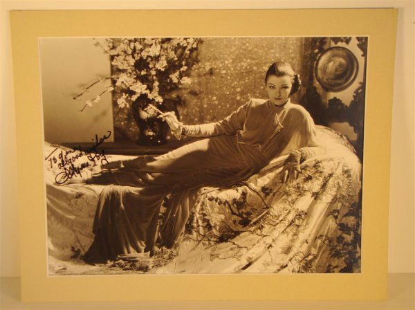 CLARENCE SINCLAIR BULL PHOTO MYRNA LOY ISP: ISP to Gene Andrewski "To Gene All Good Wishes, Myrna Loy" in black ink. Dated 12-2-32, Back stamp Clarence Sinclair Bull, Metro-Goldwyn-Mayer No. 640 x-31. Typed publicity stamp "Myrna Loy as Fah So