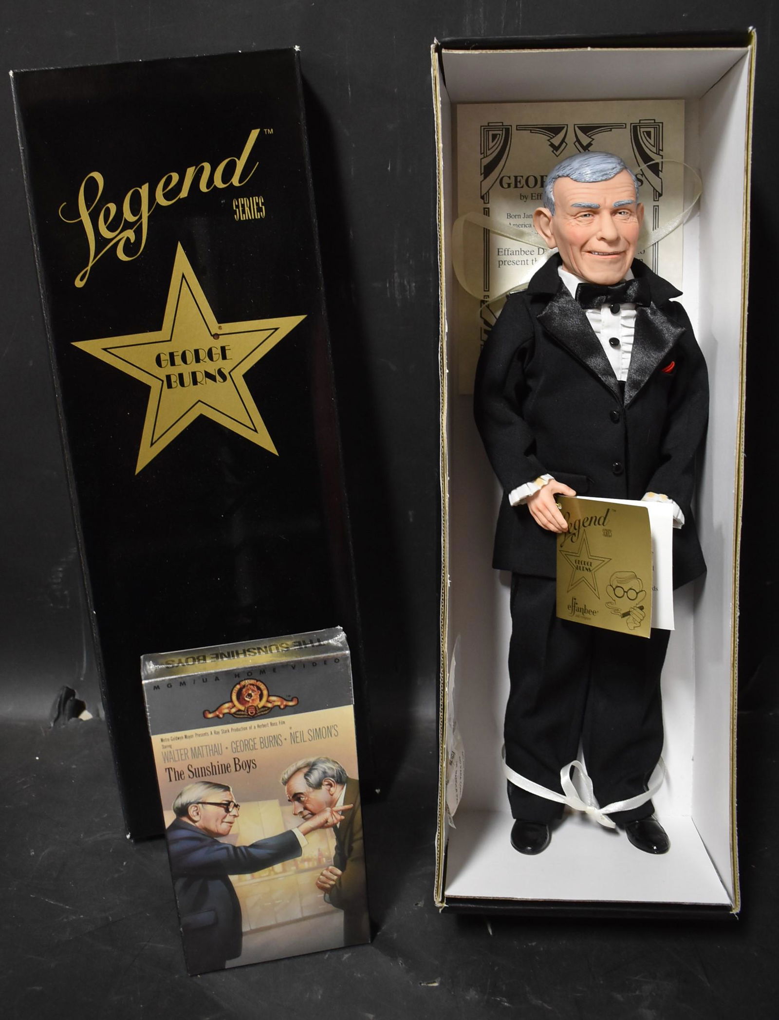 Legends Series George Burns Doll: A 1996 Legends Series doll of actor George Burns, by Effanbee Doll Company. Also included is a sealed VHS tape copy of his movie "The Sunshine Boys". In original box.