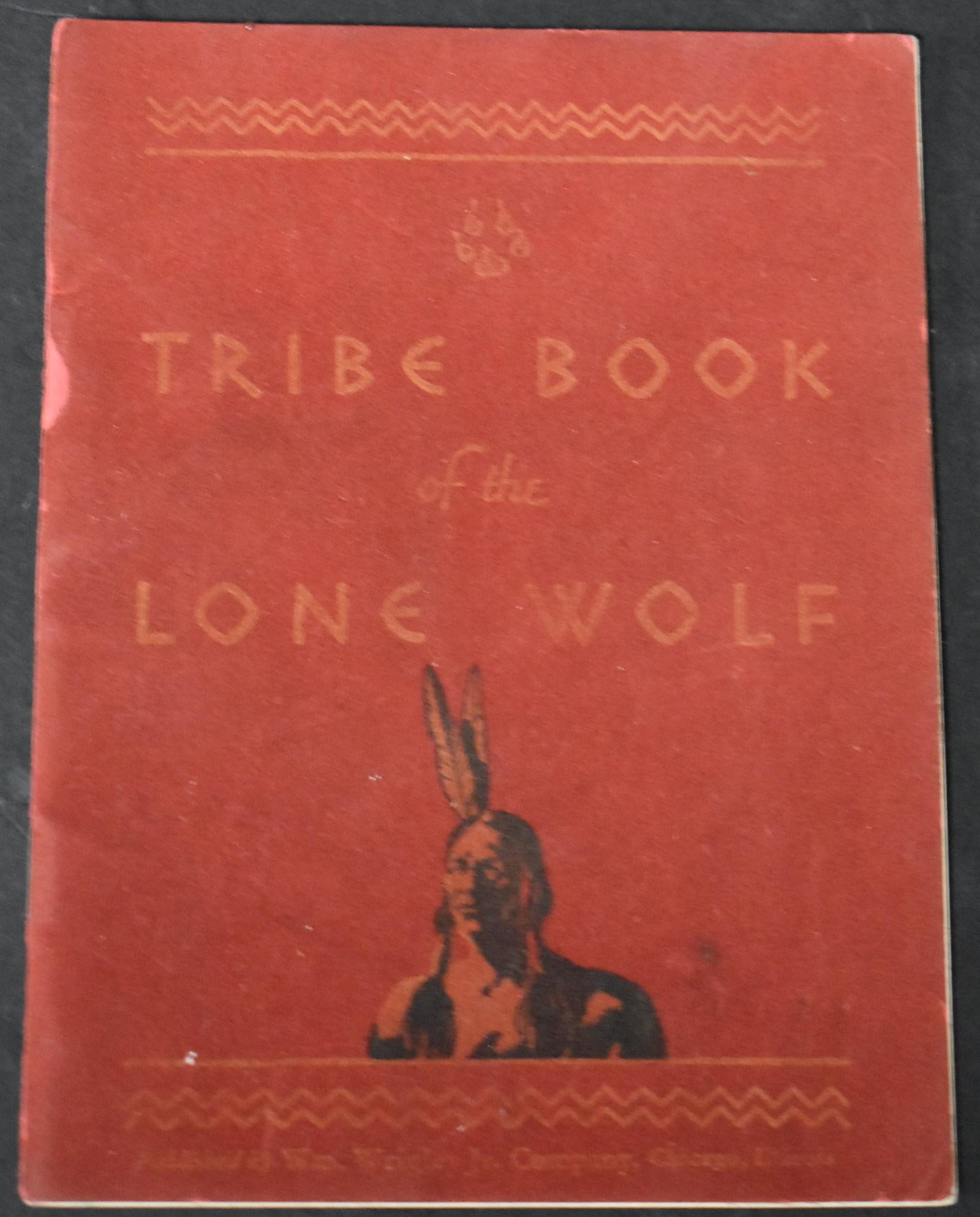 Tribe Book of the Lone Wolf & Arrowhead: C. 1932. W.M. Wrigley Co. The book illustrates picture writing used by the Lone Wolf tribe. Also describes and pictues the tribe necklace (arrowhead) included in the lot. Also includes ad for Wrigley 