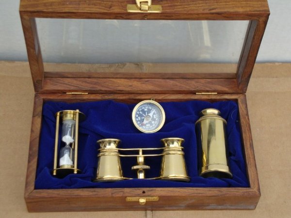 BRASS NAUTICAL INSTRUMENT BOX: Includes: binoculars, adjustable telescope, compass, hourglass. In a glass topped case,2 1/2"H. 9"L