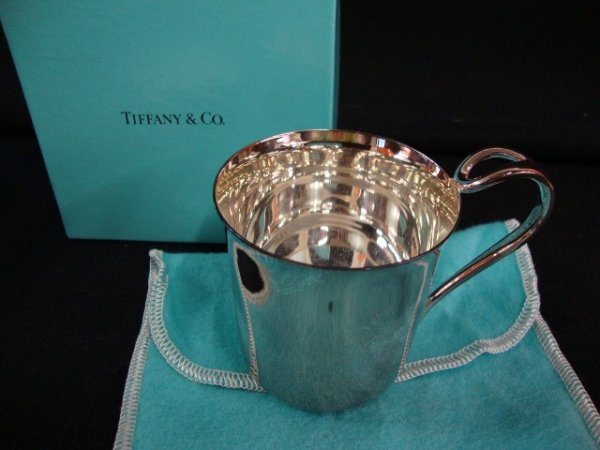 TIFFANY & CO. STERLING BABY CUP: Tiffany & Co. sterling silver baby cup. Padora pattern by Elsa Peretti. In original blue bag and box. 2-1/4" h.