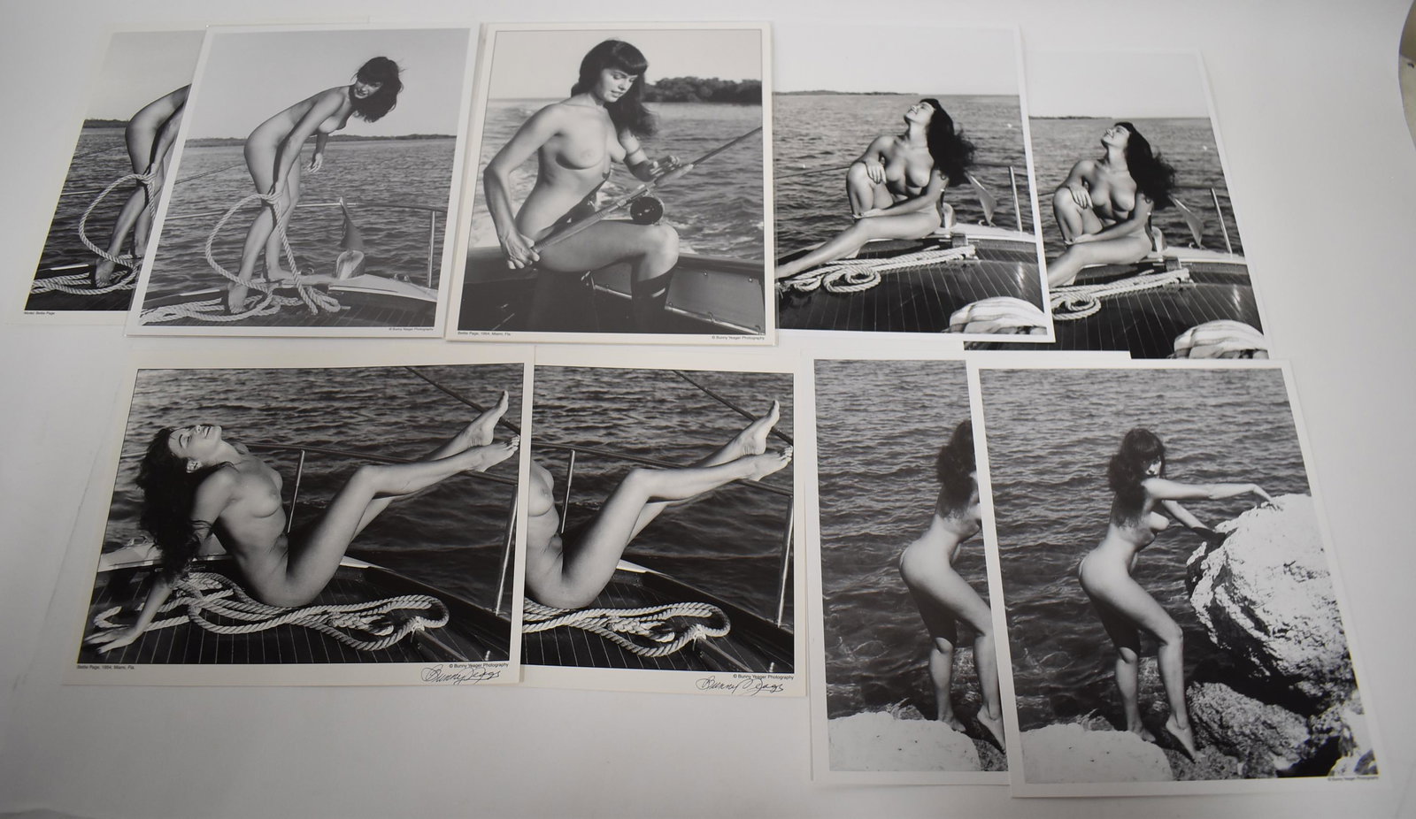 (9) Photos Bettie Page. (2) Sgd.: (9) Photos Bettie Page on Boat (2) Sgnd. Bunny Yeager.(5) Different Poses.
