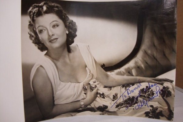 INSCRIBED MYRNA LOY 1939 PHOTOGRAPH: To David, Best Wishes, Myrna Loy in blue ink. A publicity portrait for The Rain Came, 1939. 8-1/2 x 11