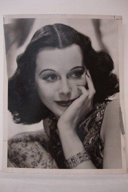 CLARENCE BULL PHOTOGRAPH OF HEDY LAMARR: Backstamp for Clarence Bull - "Please credit MGM photo by Clarence Bull", backstamp for Photoplay, Publicity Snipe typed in at back, "July 1938 photo to use in 1941 issue of Movie Magazine" 10" W X 13