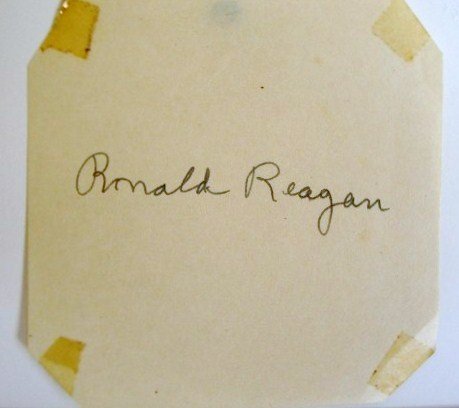 RONALD REAGAN STILL AND AUTOGRAPH: Publicity snipe at back re: Ronald Reagan as Grover Cleveland Alexander in The Winning Team. Photographed with Bob Lemmon, pitching all of the Cleveland Indians who portrayed Jess Haines, star pitcher