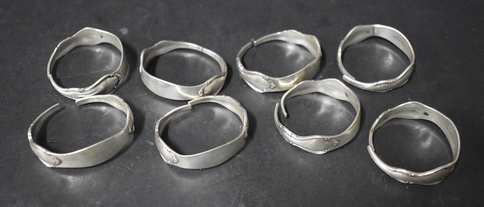 Reed and Barton Sterling Silver Napkin Rings (8): Unusual in the form of a wrapped around pc. of flatware Marked Reed and Barton Sterling
