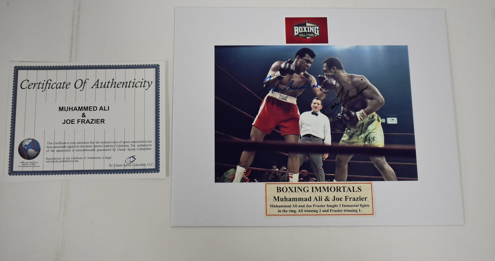 Muhammad Ali & Joe Frazier Sgd. Photo: Includes COA. 8 x10.