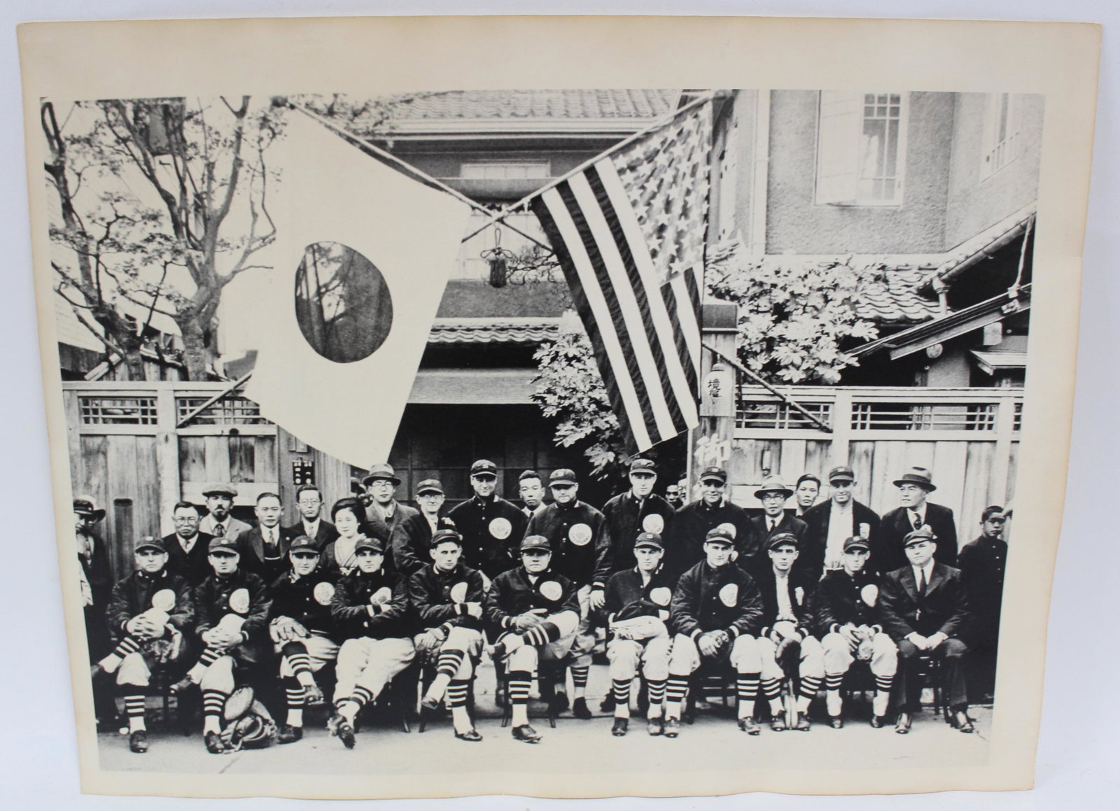 Rare photo, Yankees in Japan: Babe Ruth seated at the middle. Flags of the two nations flying above the group shot with dignitaries.